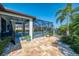 Outdoor patio and pool area with a screened-in enclosure, landscaped yard, and picturesque lake view at 12830 24Th Street E Cir, Parrish, FL 34219