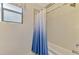 Shower and tub featuring a blue and white shower curtain and a window at 12830 24Th Street E Cir, Parrish, FL 34219