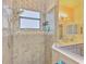 Bathroom shower featuring beige tile and a chrome shower head at 12830 24Th Street E Cir, Parrish, FL 34219