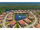 Enjoy an aerial view of the homes encircling a beautiful community lake with fountain at 141 Bella Vista Ter # 34D, Nokomis, FL 34275