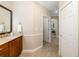Bathroom showcasing vanity with granite counters and tile floors with views of hall at 141 Bella Vista Ter # 34D, Nokomis, FL 34275