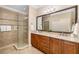 Bathroom with double sinks, granite countertops, and a glass walk-in shower at 141 Bella Vista Ter # 34D, Nokomis, FL 34275