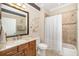 Bathroom showcasing vanity, toilet, shower, and decorative seashell accents at 141 Bella Vista Ter # 34D, Nokomis, FL 34275