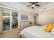 Bedroom with a sliding glass door to a lanai and a dresser with a television at 141 Bella Vista Ter # 34D, Nokomis, FL 34275