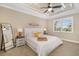 Bedroom with a ceiling fan, large window, and a neutral color palette at 141 Bella Vista Ter # 34D, Nokomis, FL 34275