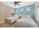 Bright bedroom featuring two beds, soft hues, and coordinated decor at 141 Bella Vista Ter # 34D, Nokomis, FL 34275