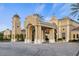 Elegant clubhouse entrance with clock tower, featuring grand architectural details and well-manicured landscaping at 141 Bella Vista Ter # 34D, Nokomis, FL 34275