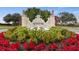 Picturesque entrance sign with lush plants and lion statues, embodying the community's prestige at 141 Bella Vista Ter # 34D, Nokomis, FL 34275