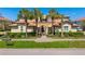 Inviting two-story home with palm trees and manicured landscaping creating a welcoming curb appeal at 141 Bella Vista Ter # 34D, Nokomis, FL 34275