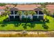 Beautiful two story building showcasing lush landscaping and serene lake views at 141 Bella Vista Ter # 34D, Nokomis, FL 34275