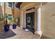Elegant front entrance with a decorative glass door and inviting blue potted plants at 141 Bella Vista Ter # 34D, Nokomis, FL 34275