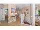 Bright hallway featuring neutral colors, stairs, and a glimpse of a bedroom with soft blue accents at 141 Bella Vista Ter # 34D, Nokomis, FL 34275