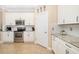 Bright kitchen features granite countertops, a subway tile backsplash and stainless steel appliances at 141 Bella Vista Ter # 34D, Nokomis, FL 34275