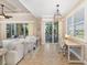 Bright living room featuring sliding glass doors, tile flooring, and neutral decor at 141 Bella Vista Ter # 34D, Nokomis, FL 34275