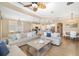 Open-concept living room and kitchen featuring tile floors, comfortable sofas, and a well-equipped kitchen at 141 Bella Vista Ter # 34D, Nokomis, FL 34275