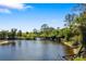 Picturesque view of the river with beautiful trees under a clear blue sky at 141 Bella Vista Ter # 34D, Nokomis, FL 34275