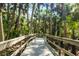 Charming wooden walkway winding through a serene palm forest at 141 Bella Vista Ter # 34D, Nokomis, FL 34275