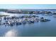 Aerial view shows a marina with boats docked along a waterfront community at 1613 4Th E St, Palmetto, FL 34221