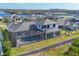 Aerial view of beautiful home featuring screened in lanai with pool, a well manicured lawn, and stylish roof at 1613 4Th E St, Palmetto, FL 34221