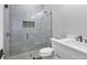 Modern bathroom featuring a glass shower, white vanity, and chrome fixtures at 1613 4Th E St, Palmetto, FL 34221