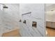 Luxurious bathroom featuring a marble tile shower and modern fixtures at 1613 4Th E St, Palmetto, FL 34221