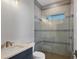 Contemporary bathroom with a glass enclosed shower with gray accent tiles and modern fixtures at 1613 4Th E St, Palmetto, FL 34221