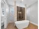 Luxurious bathroom featuring a soaking tub, floor to ceiling marble shower, and modern fixtures at 1613 4Th E St, Palmetto, FL 34221