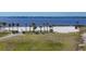 A sandy beach with palm trees offers a serene waterfront experience, ideal for relaxation and recreation at 1613 4Th E St, Palmetto, FL 34221