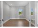 Spacious, naturally lit bedroom with wood-look tile and a lovely view of tropical landscaping at 1613 4Th E St, Palmetto, FL 34221