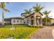 This charming clubhouse showcases a meticulously maintained lawn, stone pillars, and inviting entrances at 1613 4Th E St, Palmetto, FL 34221