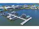 This aerial view features a private boat dock with multiple slips, perfect for waterfront living and boating enthusiasts at 1613 4Th E St, Palmetto, FL 34221