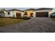 Attractive brick driveway leads to a modern three-car garage, enhanced by well-kept landscaping at 1613 4Th E St, Palmetto, FL 34221