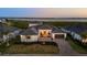 Beautiful waterfront home with a brick driveway, manicured lawn, and picturesque ocean view at 1613 4Th E St, Palmetto, FL 34221