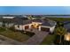 Stunning waterfront home features a manicured lawn, brick driveway, and three-car garage at 1613 4Th E St, Palmetto, FL 34221