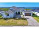 Beautiful home exterior features lush landscaping, a paver driveway, and a three car garage at 1613 4Th E St, Palmetto, FL 34221