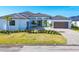 Charming home boasts manicured lawn, palm trees, and a stylish paver driveway, offering curb appeal at 1613 4Th E St, Palmetto, FL 34221