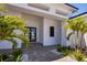 Front entryway with decorative landscaping and elegant facade creating a welcoming entrance at 1613 4Th E St, Palmetto, FL 34221