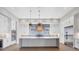This spacious kitchen features a large island, white cabinets, stainless steel appliances, and pendant lighting at 1613 4Th E St, Palmetto, FL 34221