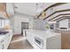 Bright kitchen features a large island, stainless steel appliances, and open access to the living area at 1613 4Th E St, Palmetto, FL 34221