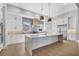 A well-lit kitchen boasting a center island, stainless steel appliances, and modern pendant lighting at 1613 4Th E St, Palmetto, FL 34221