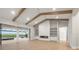 The living room features hardwood floors, exposed beams, a fireplace, and sliding glass doors at 1613 4Th E St, Palmetto, FL 34221