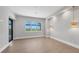 Bright living room with large window offering a picturesque landscape view at 1613 4Th E St, Palmetto, FL 34221