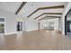 Spacious living room flows into open kitchen; wood beams accent the vaulted ceiling at 1613 4Th E St, Palmetto, FL 34221