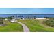 Enjoy a scenic paved path through a lush green park, leading to a sandy beach on the tranquil waters at 1613 4Th E St, Palmetto, FL 34221