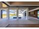 Large covered patio with wood ceilings, tile floors, and a view of the pool and yard at 1613 4Th E St, Palmetto, FL 34221