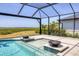 Enjoy this screened pool and spa featuring gorgeous water bowls and jets, set against a serene marshland view at 1613 4Th E St, Palmetto, FL 34221
