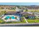 Aerial view of a community pool and pool house surrounded by tropical landscaping at 1613 4Th E St, Palmetto, FL 34221