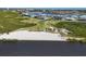 This elevated waterfront view features sandy beach access, lush greenery, and stunning views of the expansive bay at 1613 4Th E St, Palmetto, FL 34221