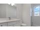 Bright bathroom featuring a modern vanity, toilet, and glass-enclosed shower, offering a clean and contemporary design at 1617 Sea Haven Dr # 501, Punta Gorda, FL 33950