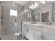 Modern bathroom featuring glass shower, double vanity, and ample lighting at 1617 Sea Haven Dr # 501, Punta Gorda, FL 33950